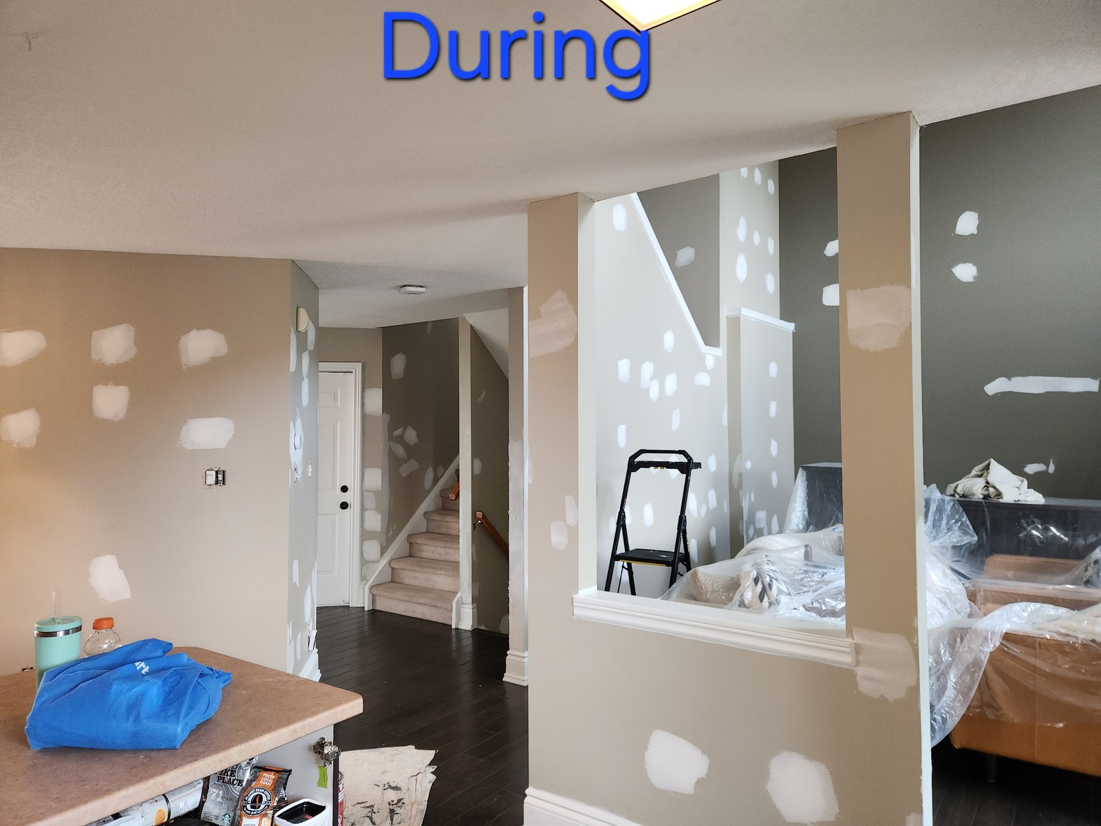 Hallway and adjoining living area during extensive wall preparation